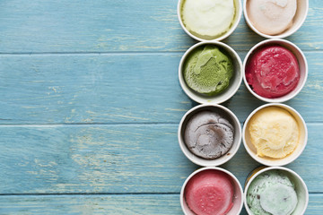 Top view of Ice cream flavors in cup and topping, sweet and dessert food concept