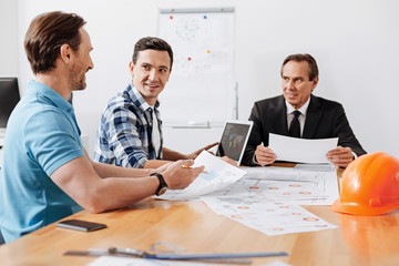 Young man reporting to his boss during the meeting