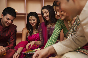 Friends making a rangoli