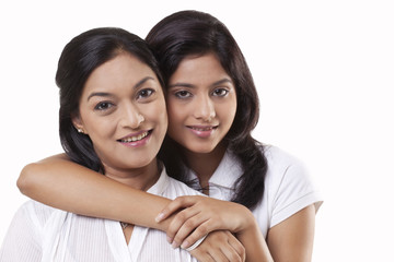 Portrait of mother and daughter embracing 