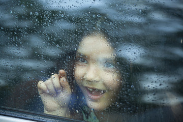 Little girl looking out of car window