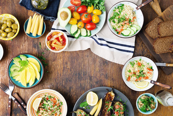 Frame from various vegetarian food on rustic wooden table