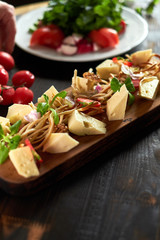 Pieces of cheese on a board with vegetables hd
