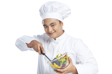Portrait of chef mixing vegetables in bowl
