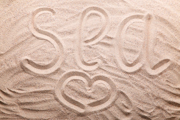 Word Sea written on beach sand