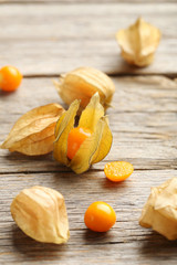 Ripe physalis on a grey wooden table