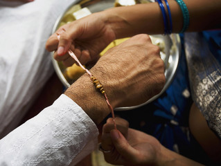 Tying a rakhi on a wrist 
