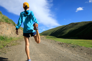 young fitness woman trail runner running on trail