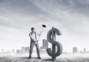Determined banker man against modern cityscape breaking dollar c