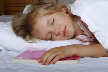 Adorable little girl sleeping in the bed