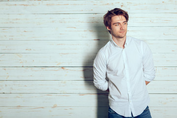 Obraz premium Portrait of a handsome man on old wooden background