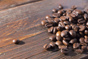 Fragrant roasted coffee on a wooden background