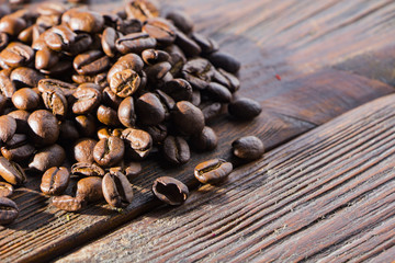 Fragrant roasted coffee on a wooden background