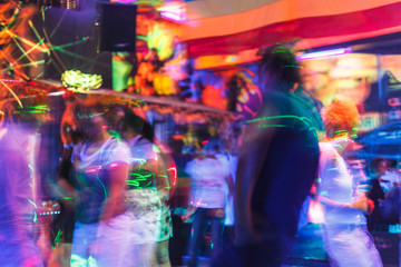 Fototapeta na wymiar People having fun in a disco. blur effect for an artistic touch
