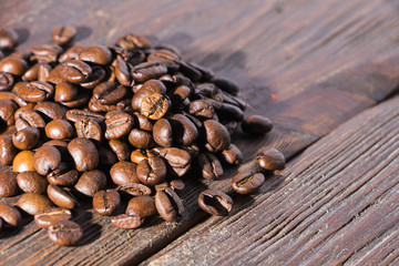 Fragrant roasted coffee on a wooden background