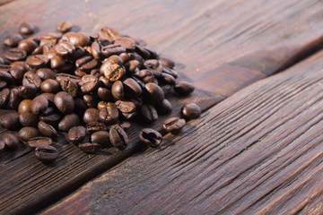 Fragrant roasted coffee on a wooden background