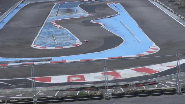 The movement of the radio-controlled car on the track.