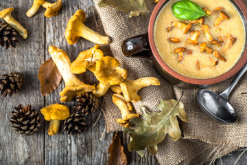 Chanterelle cream, mushroom soup, top view on wooden table..