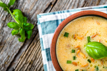 Cream soup with mushrooms cooked in a pot, overhead on wooden rustic table
