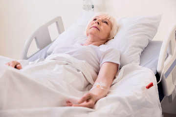 Vulnerable ill senior lady being treated in hospital