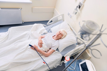 Feeble senior woman resting while recovering