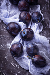 Fresh plums on concrete background