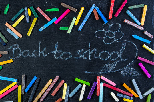 Black Chalkboard with back to school text written with white chalk on blackboard, start of education after summer holidays