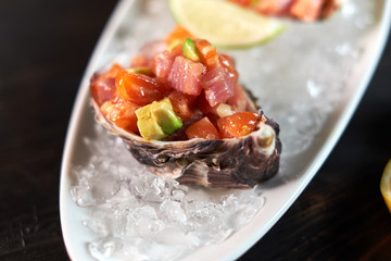 Delicious red fish in the shells of shellfish. With lemon and lime jpg