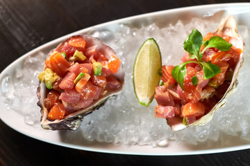 Delicious red fish in the shells of shellfish. With lemon and lime jpg