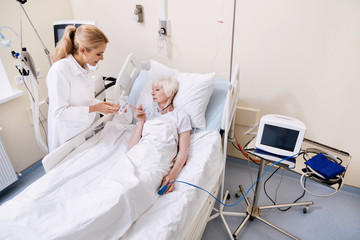 Curious neat aged woman asking her doctor for instructions