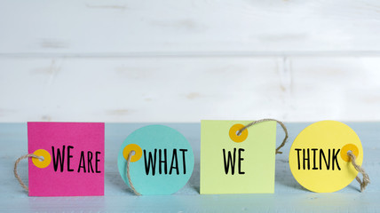 Motivational quote we are what we think on a colorful labels