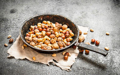 Fototapeta premium Different nuts in a frying pan.