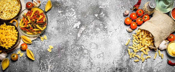 Pasta background. Pasta with sauces, vegetables and olive oil.