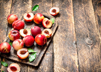 Fresh peaches with green leaves.