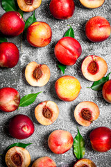 Fresh peaches with green leaves.