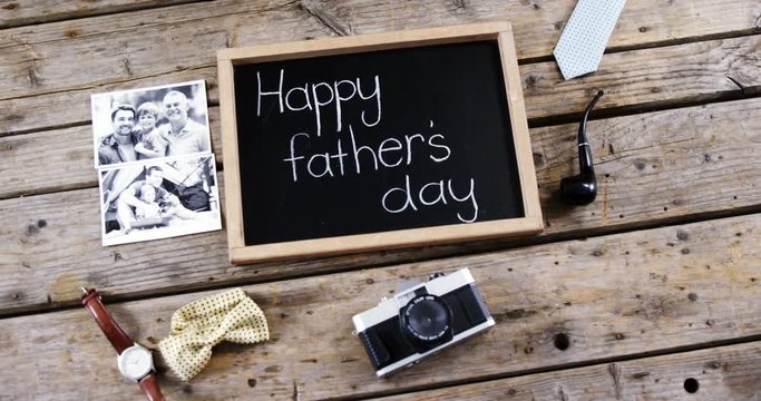 Happy fathers day message, vintage camera, photograph on wooden plank