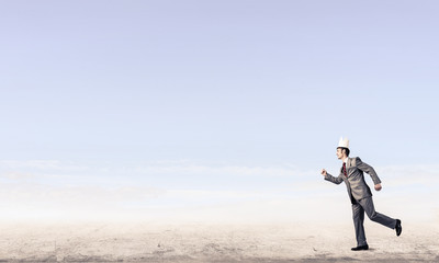 King businessman in elegant suit running and blue sky at backgro