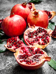 Fresh pomegranates with green leaves.