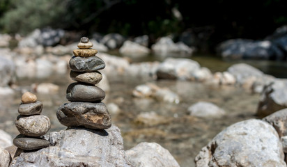 Fototapeta na wymiar balancing stones on the mountain river