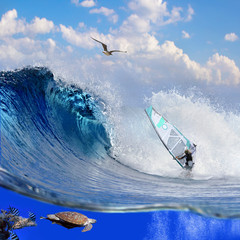 Separated image with waterline. Oceanview with breaking surfing wave and professional windsurfer on...