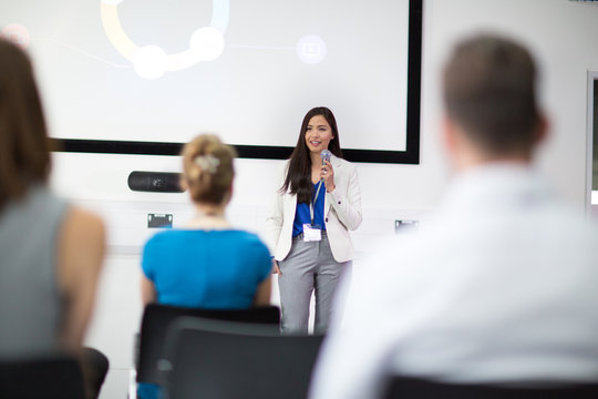 Businesswoman giving training to colleagues in conference room