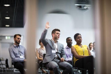 Businessman asking a question at a conference