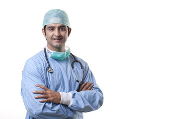Handsome male surgeon smiling over white background 