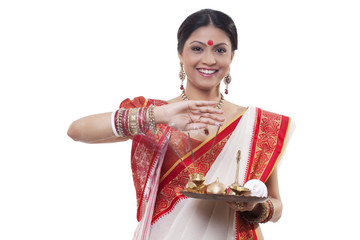 Portrait of a Bengali woman holding a puja thali