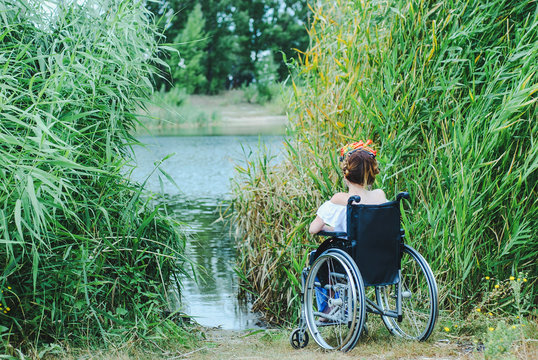 Woman in wheelchair, enjoying time outdoors