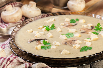 Mushroom cream soup with croutons and spices