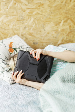 Woman hiding behind tablet computer