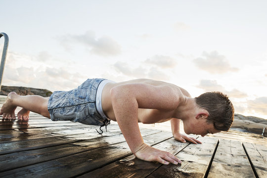 boy doing pull-ups on a jetty