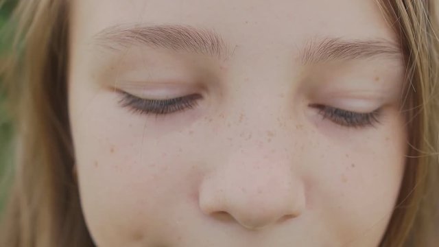Girl teenager face close-up with freckles