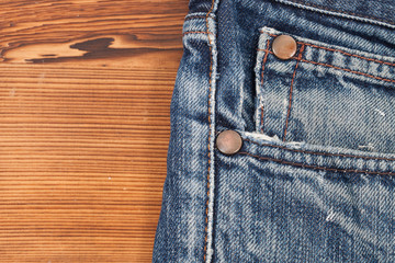 Denim pants detail with wooden background